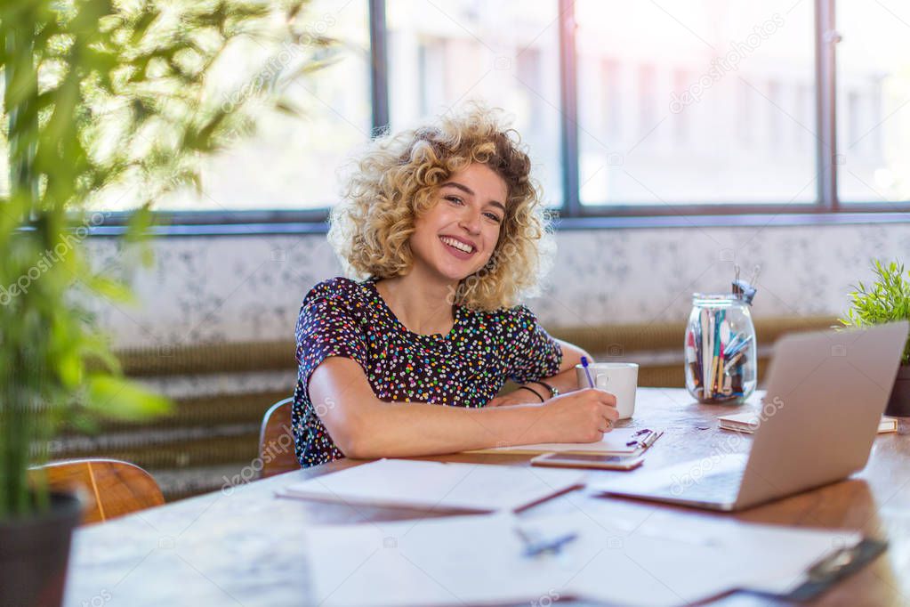 Portrait of confident creative businesswoman in office