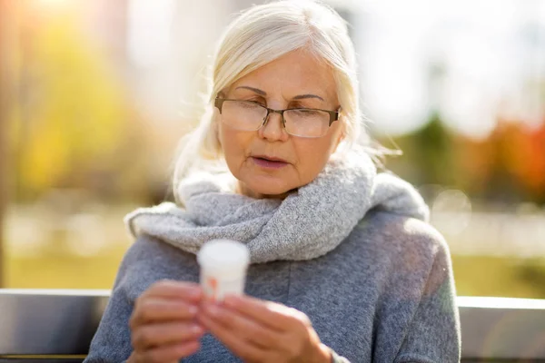 Senior Woman Taking Prescription Medicine Outdoors — Stock Photo, Image