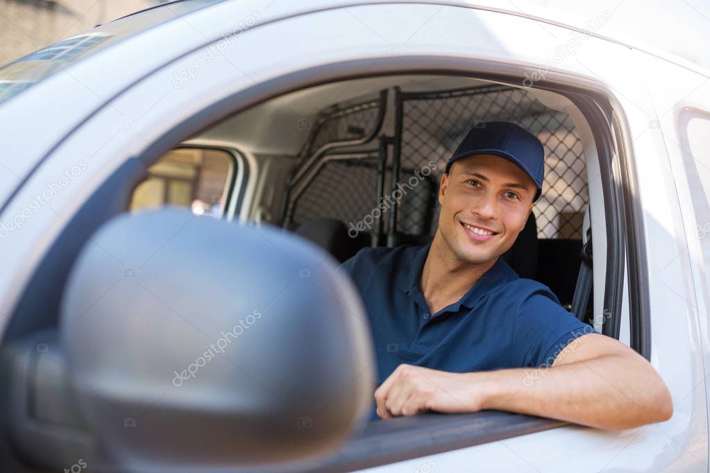 Delivery man sitting in a delivery van