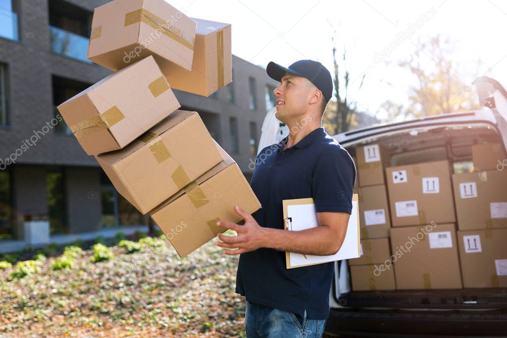 Delivery man dropping boxes 