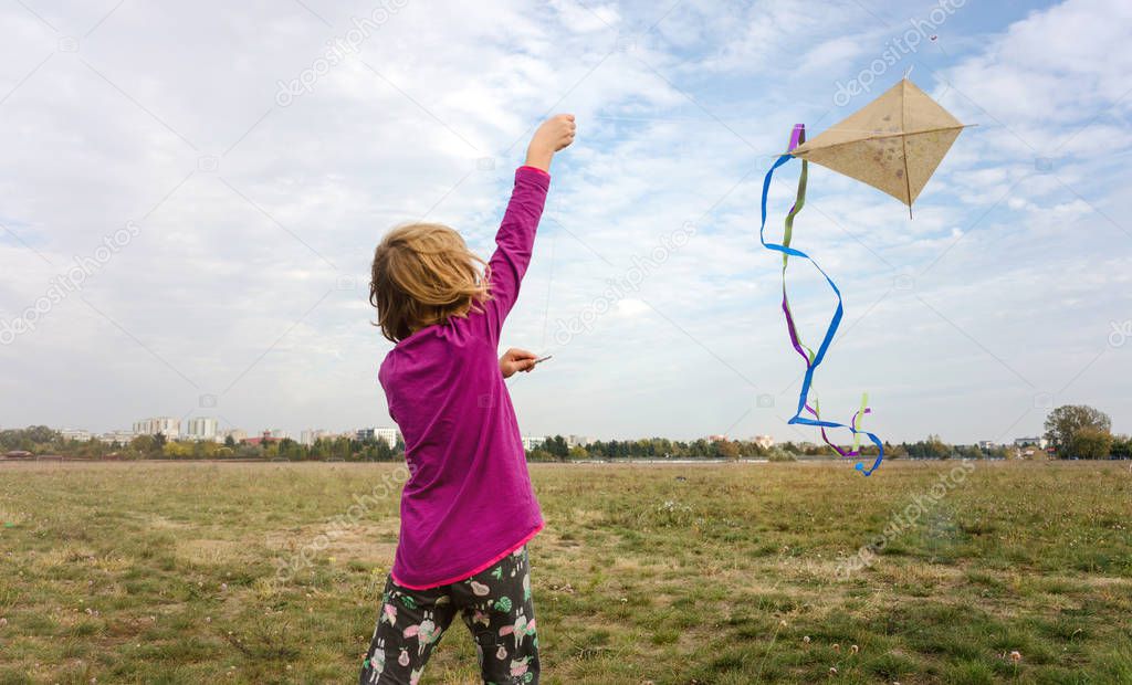 Happy little girl with a kite