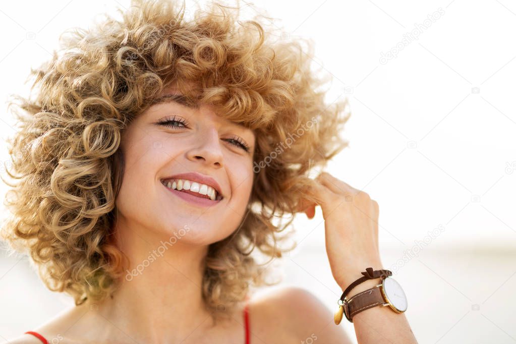 Portrait of young woman with curly hair