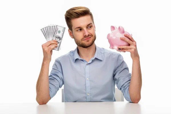 Man Geld Aanbrengend Piggy Bank Stockfoto