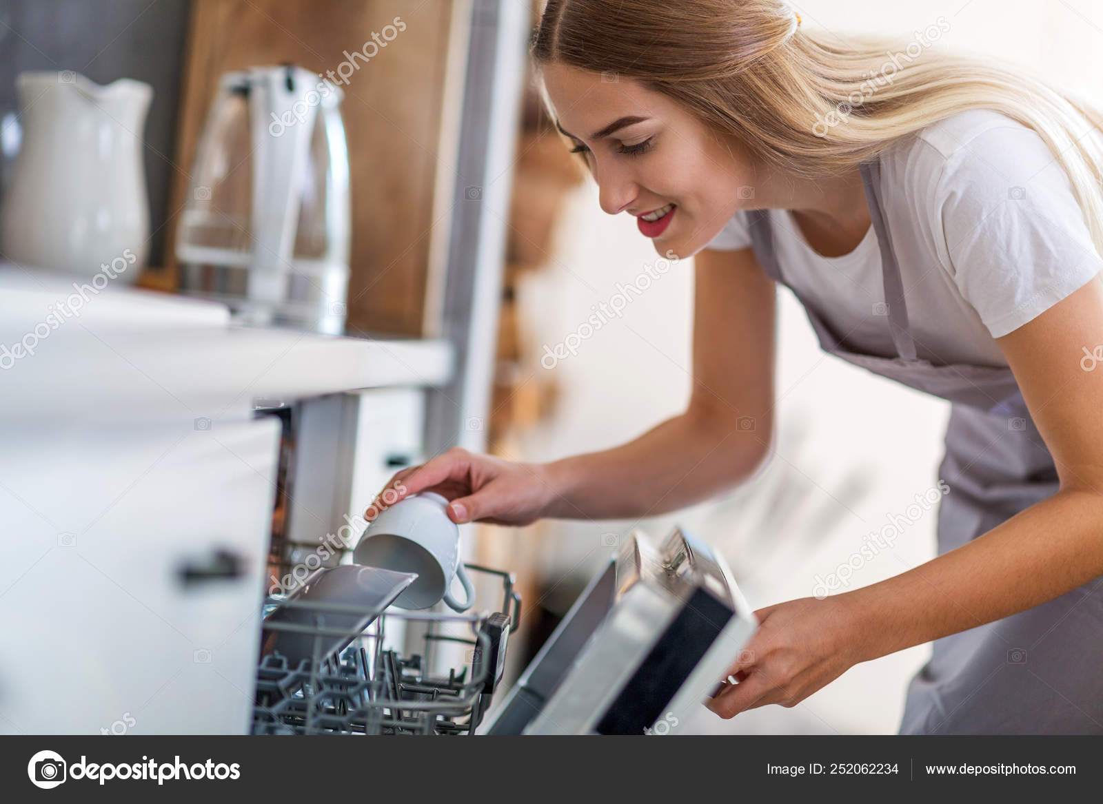Woman Putting Dishes Dishwasher — Stock Photo © pikselstock 252062234
