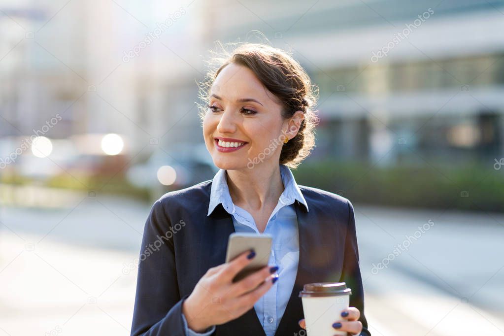 Businesswoman using mobile phone in the city