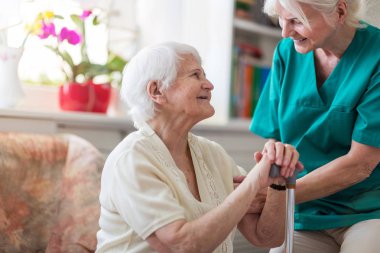 Senior woman with her female caregiver clipart
