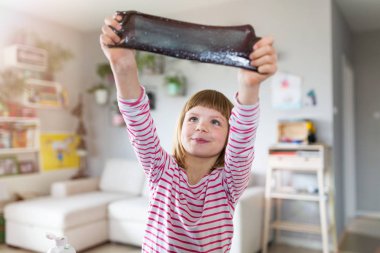 Little girl making homemade slime toy clipart