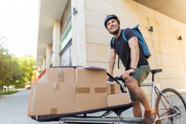Bicycle messenger making a delivery on a cargo bike clipart