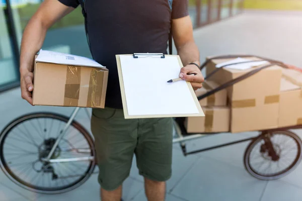 Bicycle messenger making a delivery on a cargo bike