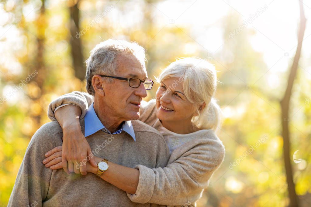 Happy senior couple in autumn park