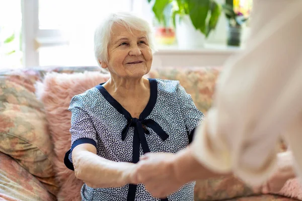Kobieta Opiekunka Domu Wspieranie Starszej Kobiety Wstać Sofy Domu Opieki — Zdjęcie stockowe