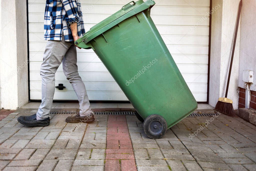 Senior man taking out garbage