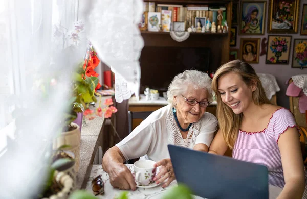 Взрослая Внучка Учит Пожилую Бабушку Пользоваться Ноутбуком — стоковое фото