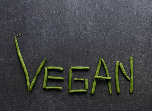 Dont eat animals The word vegan written with green beans