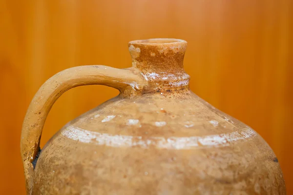 Old vintage antique earthenware jug on the table. Vintage style. Vessel for water , made for Scythian.