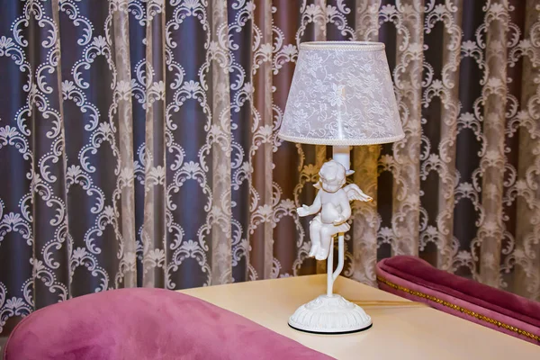 Design in elegant restaurant, floor lamp with white angel.