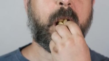 Yakın plan, sakallı adam yer, fast food, patates kızartması..
