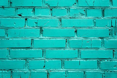 Yeşil boyayla boyanmış tuğla bir duvar parçası. Doku yakın plan.