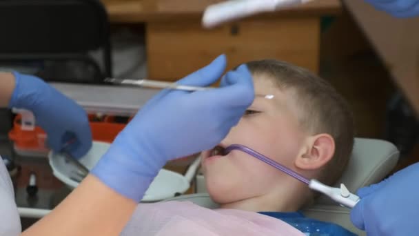 Ένα Μικρό Αγόρι Μια Καρέκλα Στο Οδοντιατρείο Γυναικείος Οδοντίατρος Προστατευτικά — Αρχείο Βίντεο