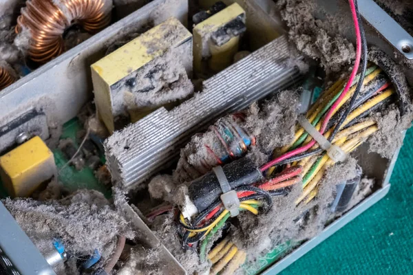 old computer power supply in a thick layer of dust.