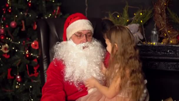 Little Girl Dress Sitting Arms Santa Claus She Straightens His — Stock Video