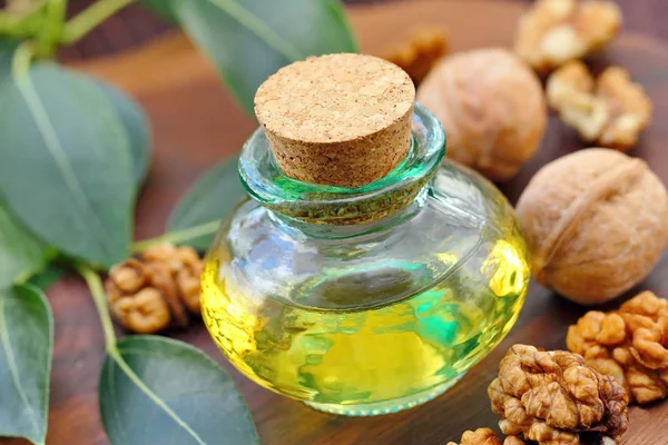 Essential aroma oil with walnut on the table