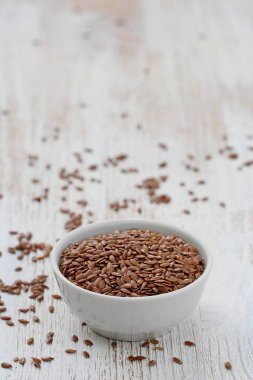 Keten tohumu. Beyaz bir kase içinde keten kahverengi tohumları