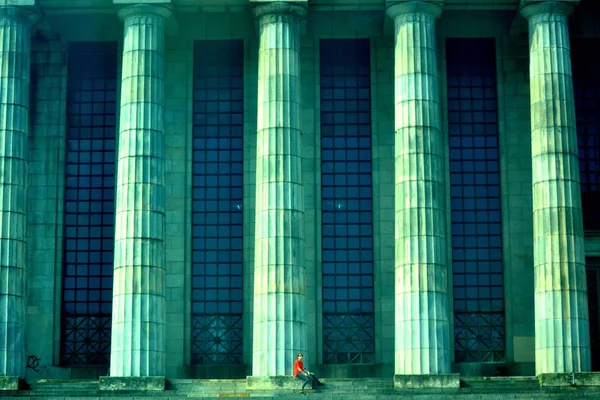 Student sitting at the stairs of the UBA law school in Buenos Aires