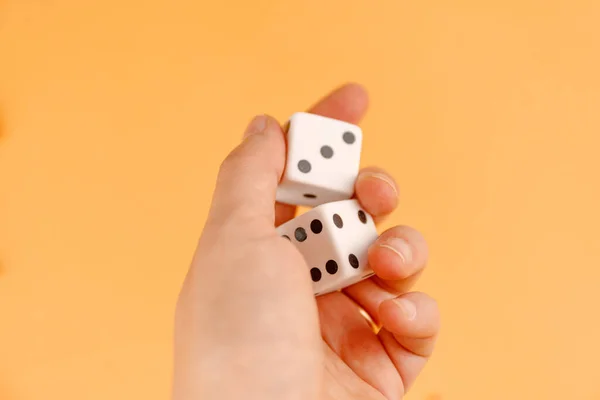 Two  dices on orange background, top ve