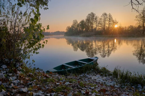 A boat is on the river at the sunrise