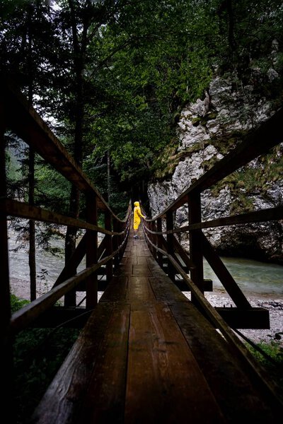human standing at old wood bridge in Slovenia