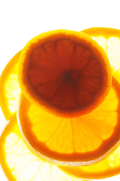 Großaufnahme Einer Gruppe Orangefarbener Scheiben Mit Backlite Auf Weißem Hintergrund — Stockfoto