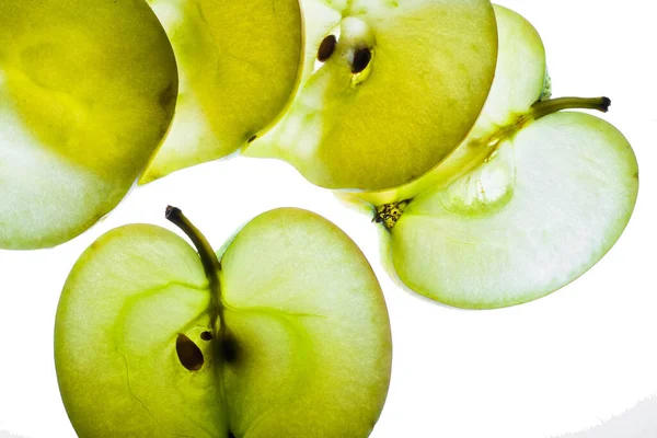 Slices of apple at the backlight isolated on a white background, macro photo Royalty Free Stock Photos