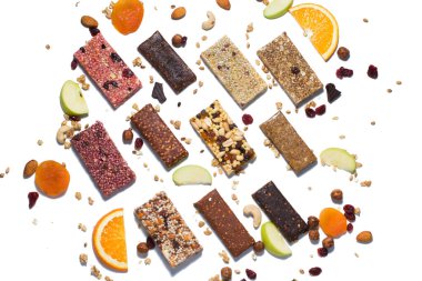 Tahıl gevreği ve beyaz arka planda fındıklı protein barları ve kuru meyve meyveleriyle bembeyaz bir bileşim yatıyordu.