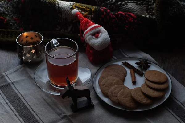 Christmas breakfast. Tea and gingerbread cookies plate, candle andsoft toy Santa — Stock Photo, Image