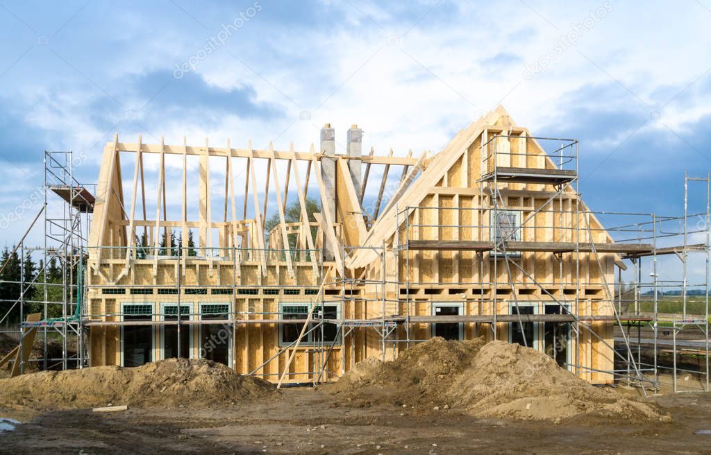 construction site of a wooden house - wood frame - scaffolding at the outside