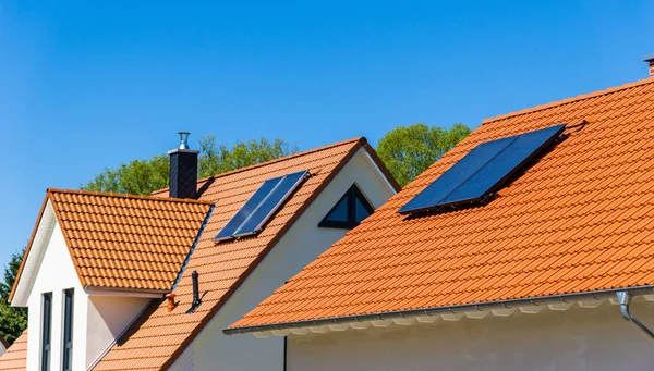 roof of a house with solar thermal plant - blue sky