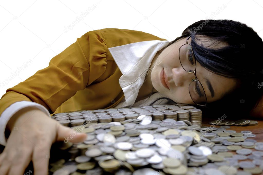 Business woman Hand Protecting With Stacked lots Coin, Portrait of beautiful happy young lady hands Pick up lots money on wooden table with white background, planning Investment and saving concept