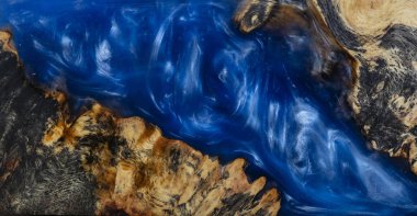 casting epoxy resin Stabilizing burl Afzelia wood blue color abstract art background for blanks clipart