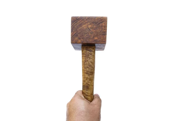 Man hand holding a mallet hammer made of burl wood tools for used by carpenter in workshop on isolated white background