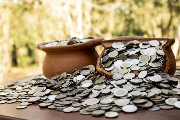 Stacking coin in broken treasure jar on blurred background, Money stack for business planning investment and saving future concept