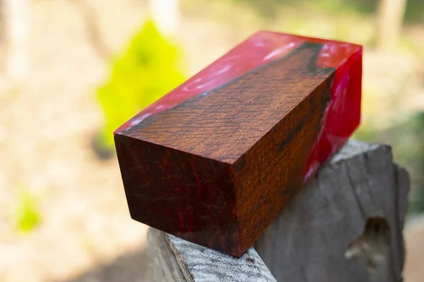 Casting epoxy resin stabilizing wood has tiger stripe red color abstract art background