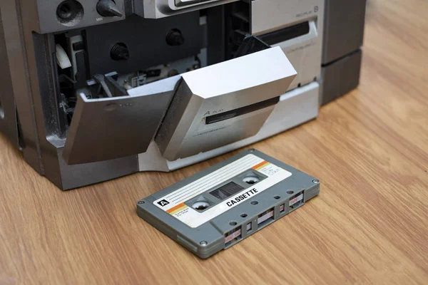 Vintage compact cassette and audio tape player on table wood background