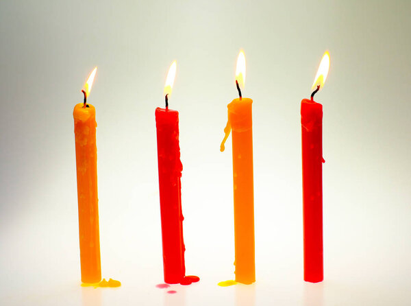 Four light flame candle burning brightly on white background