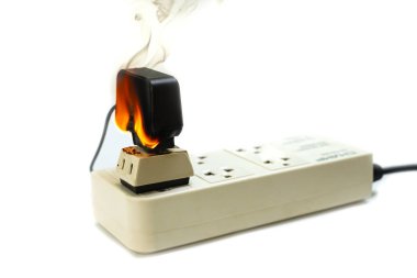 Ateşe elektrikli tel fiş priz ve bağdaştırıcı üzerinde beyaz arka plan, yanmış elektrik tel kaynaklanan elektrik kısa devre hatası