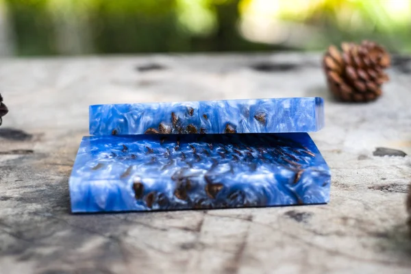 Casting epoxy resin Stabilizing pine cone blue abstract art background