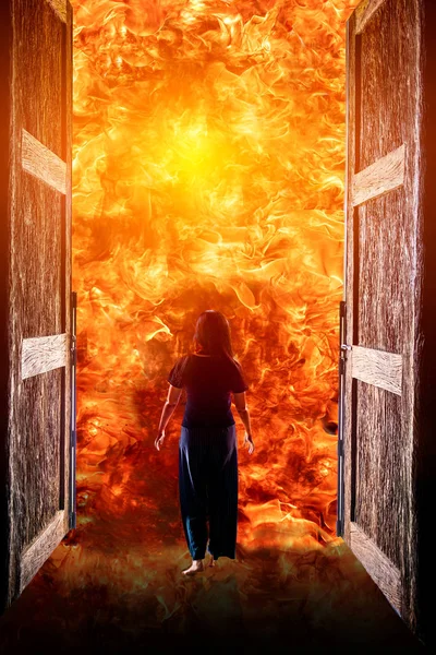 Woman walking into the fire — Stock Photo, Image