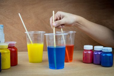 Mixing color epoxy resin in plastic cup clipart