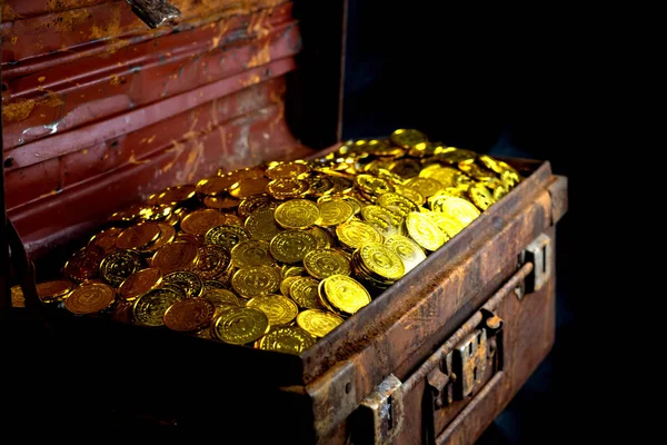 Укладка золотой монеты в сундук — стоковое фото