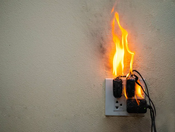 On fire Adapter an Steckdose auf weißem Hintergrund — Stockfoto